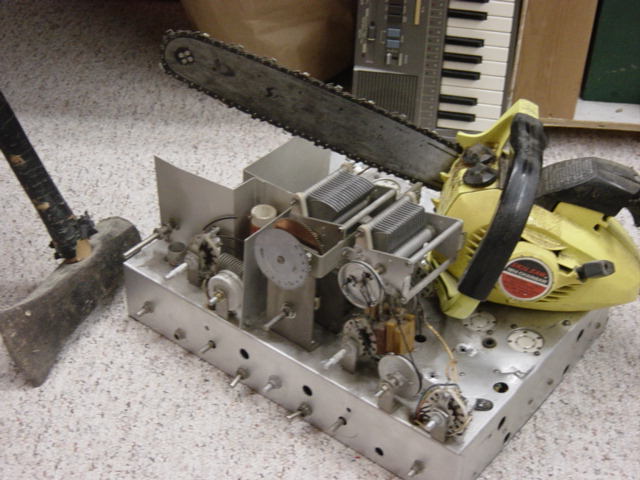 Chain saw sitting on old chassis, combination axe and sledge hammer. These tools should scare anything into working immediately